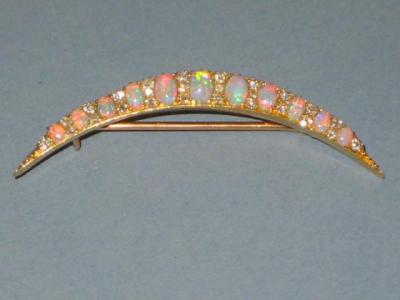 Appraisal: A VICTORIAN OPAL AND DIAMOND BROOCH of crescent form the