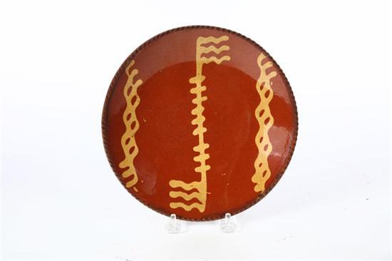 Appraisal: REDWARE PIE PLATE American mid th century Coggled rim and