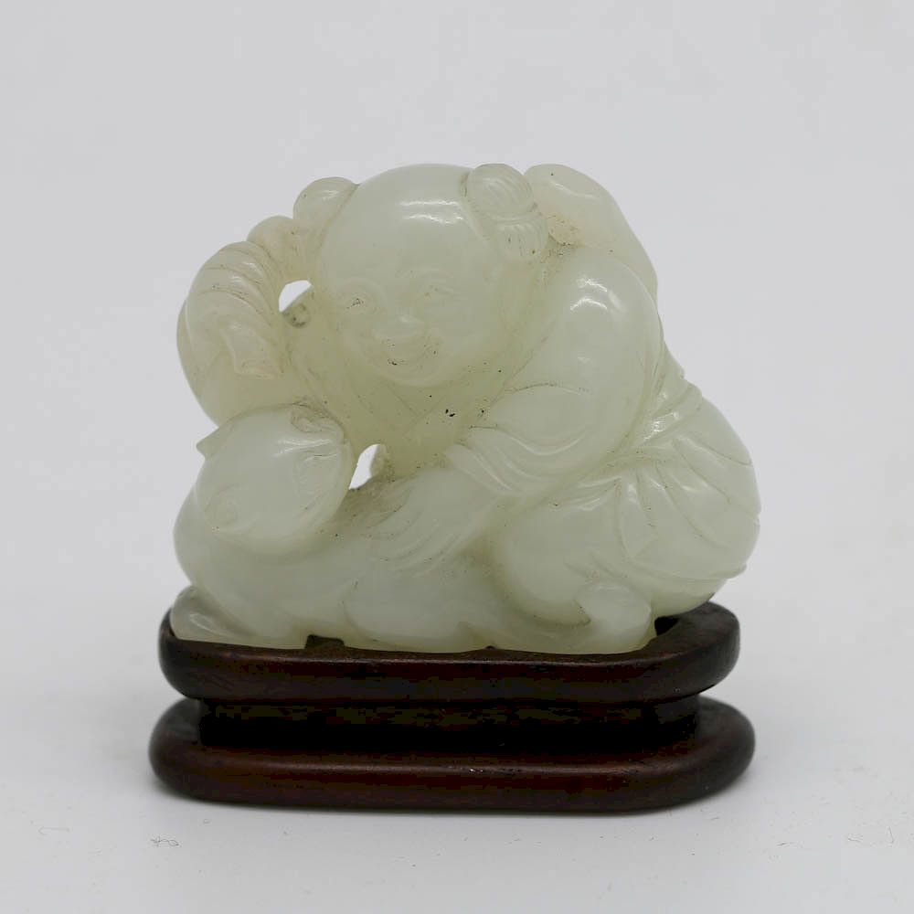 Appraisal: WHITE JADE BOY AND CAT GROUP QIANLONG PERIOD Depicting a