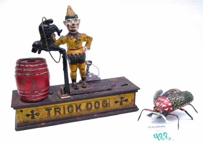 Appraisal: TWO METAL TOYS cast iron ''Trick Dog'' mechanical bank painted