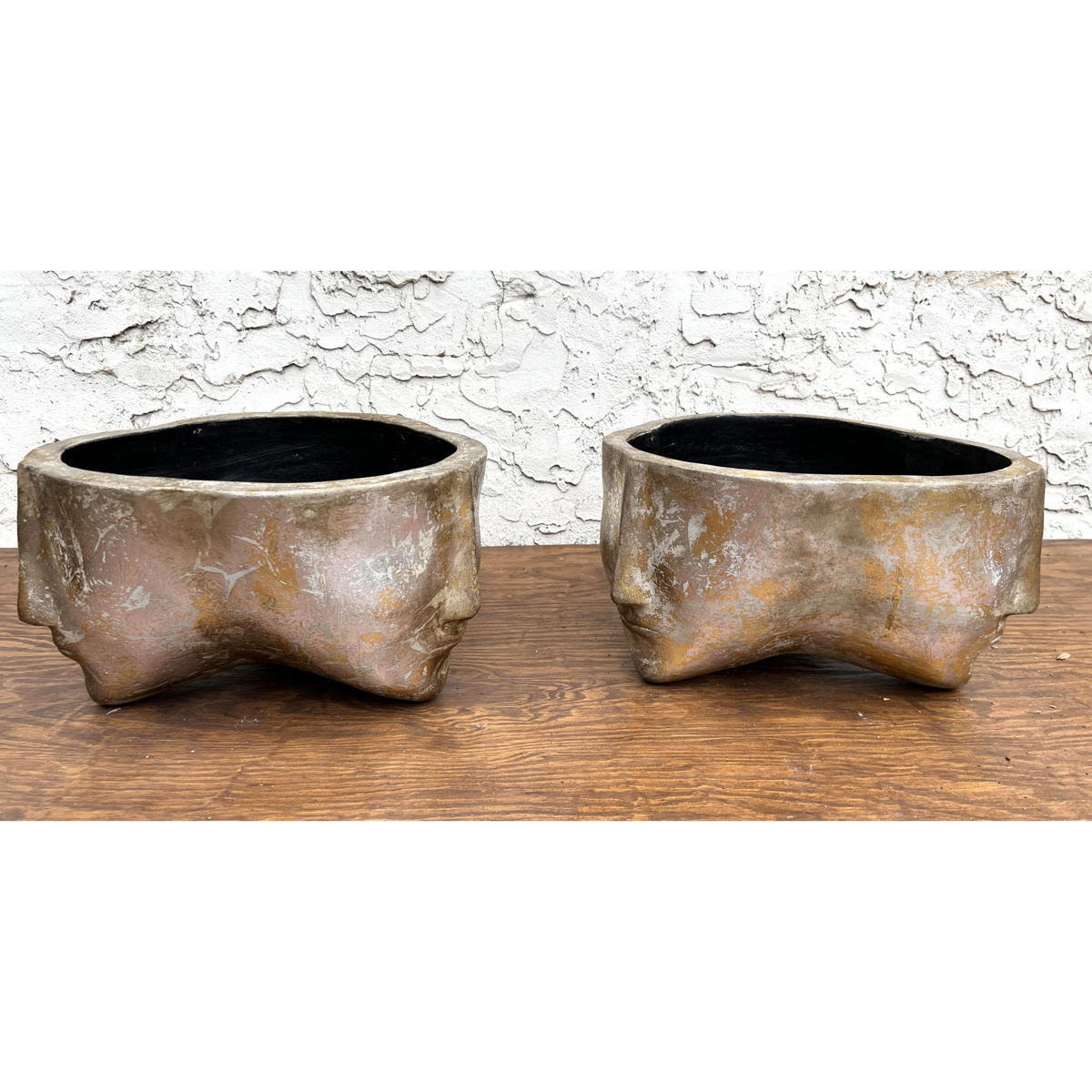 Appraisal: Pair Three Face Planters Pottery with metallic painted finish Dimensions