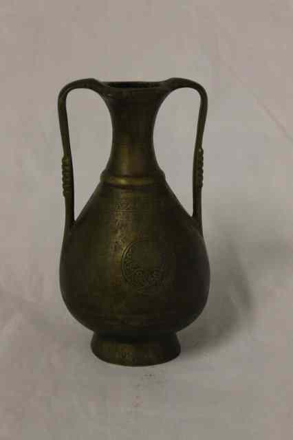 Appraisal: A BRONZE PROBABLY IRANIAN TWO HANDLED VASE with simple engraved