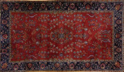 Appraisal: KASHAN CARPET The wine red field with floral branches within