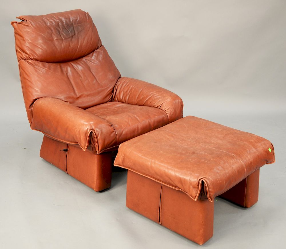 Appraisal: Modern maroon and leather club chair to include matching footstool