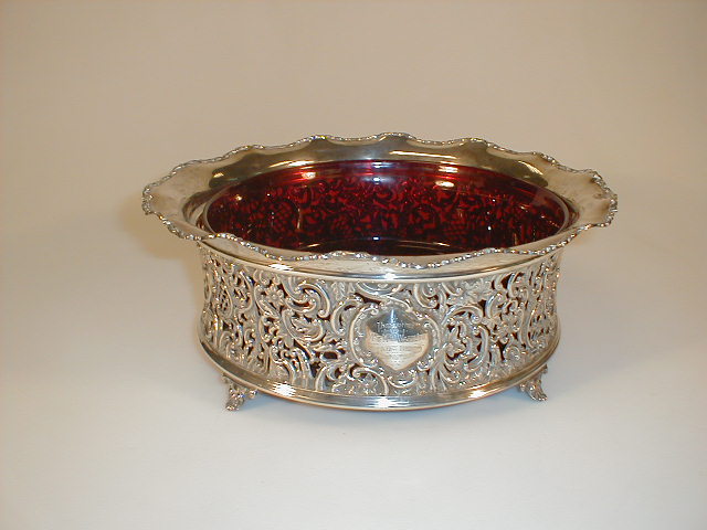 Appraisal: A late Victorian silver fruit basket with a cranberry glass