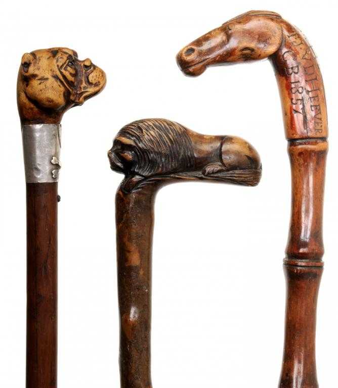 Appraisal: THREE ZOOMORPHIC WALKING CANES one of bamboo carved by a