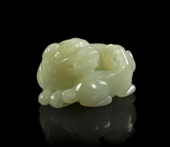 Appraisal: A White Jade Carving of a Lion and Pup the