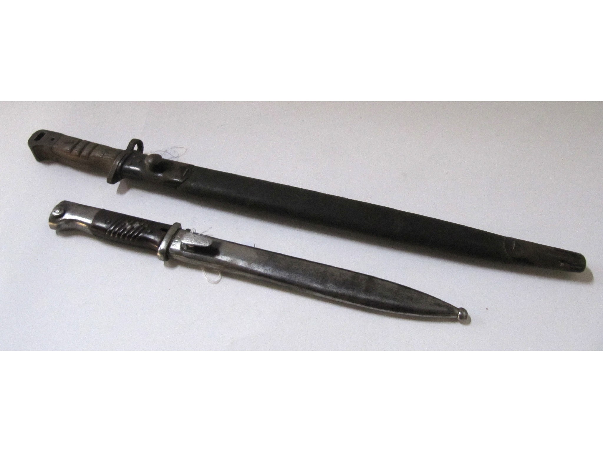 Appraisal: A lot comprising two bayonets in scabbards