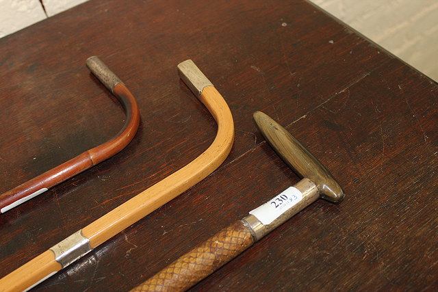 Appraisal: A HORN HANDLE WALKING STICK with snake skin cover shaft