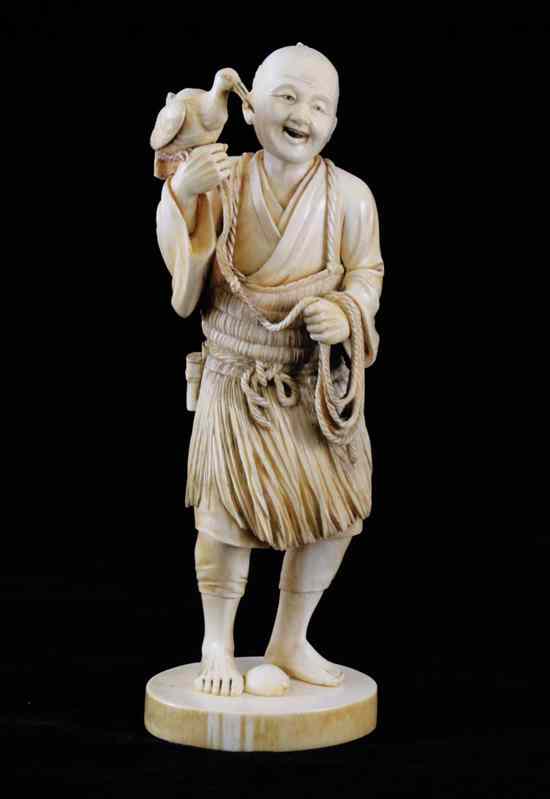 Appraisal: A Japanese ivory figure of a fisherman Meiji period -