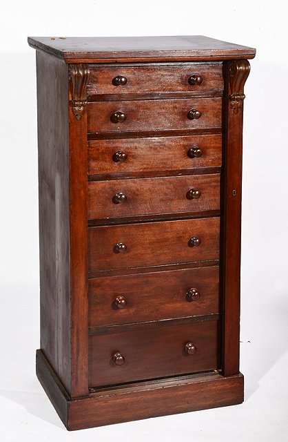 Appraisal: A TH CENTURY MAHOGANY WELLINGTON CHEST with scroll mounts to