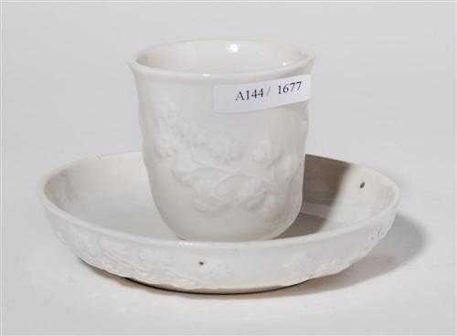 Appraisal: WHITE CUP AND SAUCER WITH LARGE FOLIATE RELIEF Nymphenburg circa