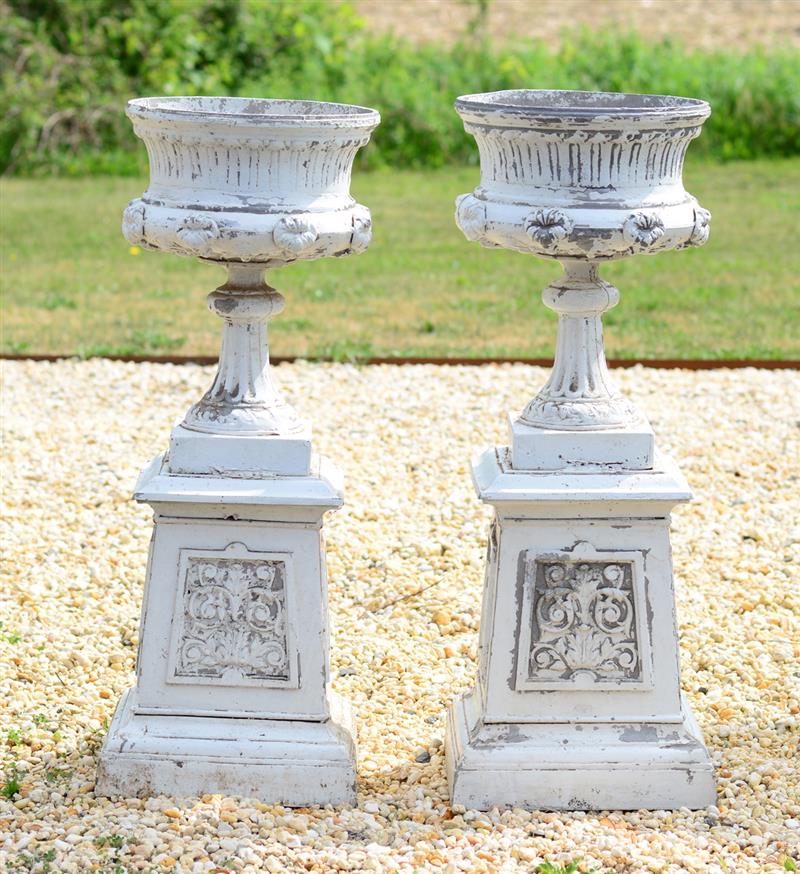 Appraisal: TWO LARGE PAINTED METAL URNS ON STANDS Each waisted urn