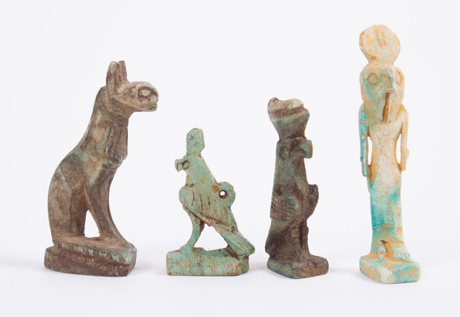 Appraisal: Four ancient Egyptian faience amulets comprising a seated cat in