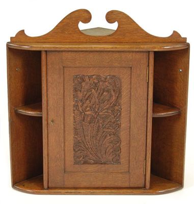 Appraisal: A carved oak corner cupboard in the manner of Arthur