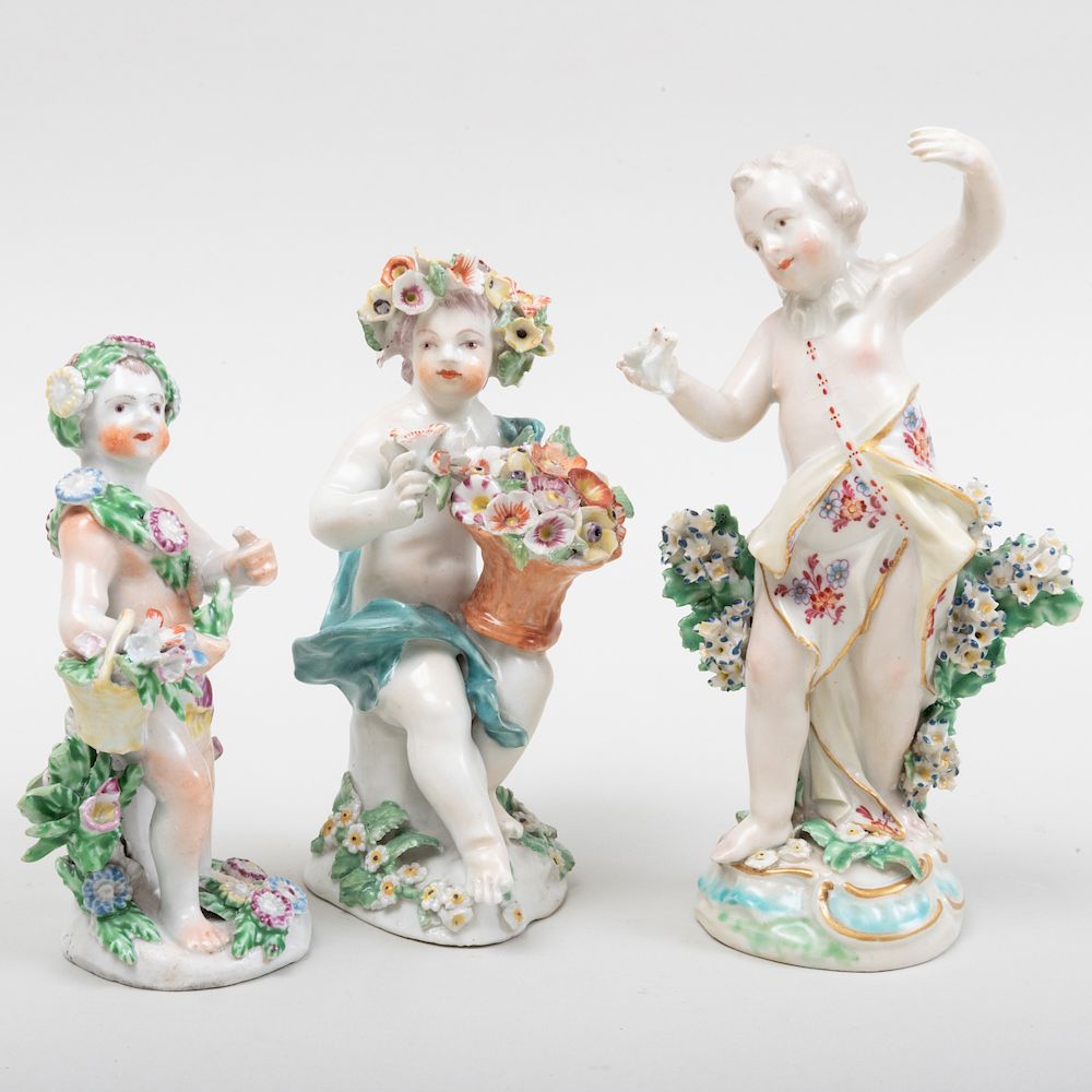 Appraisal: Group of Three English Porcelain Figures of Putti with Flowers