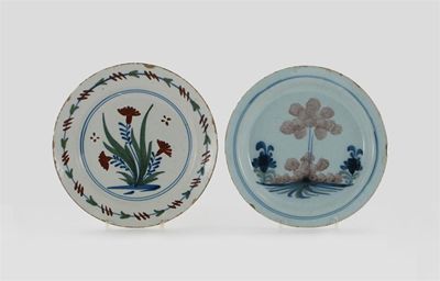 Appraisal: Two delftware plates one painted with flowers in red blue