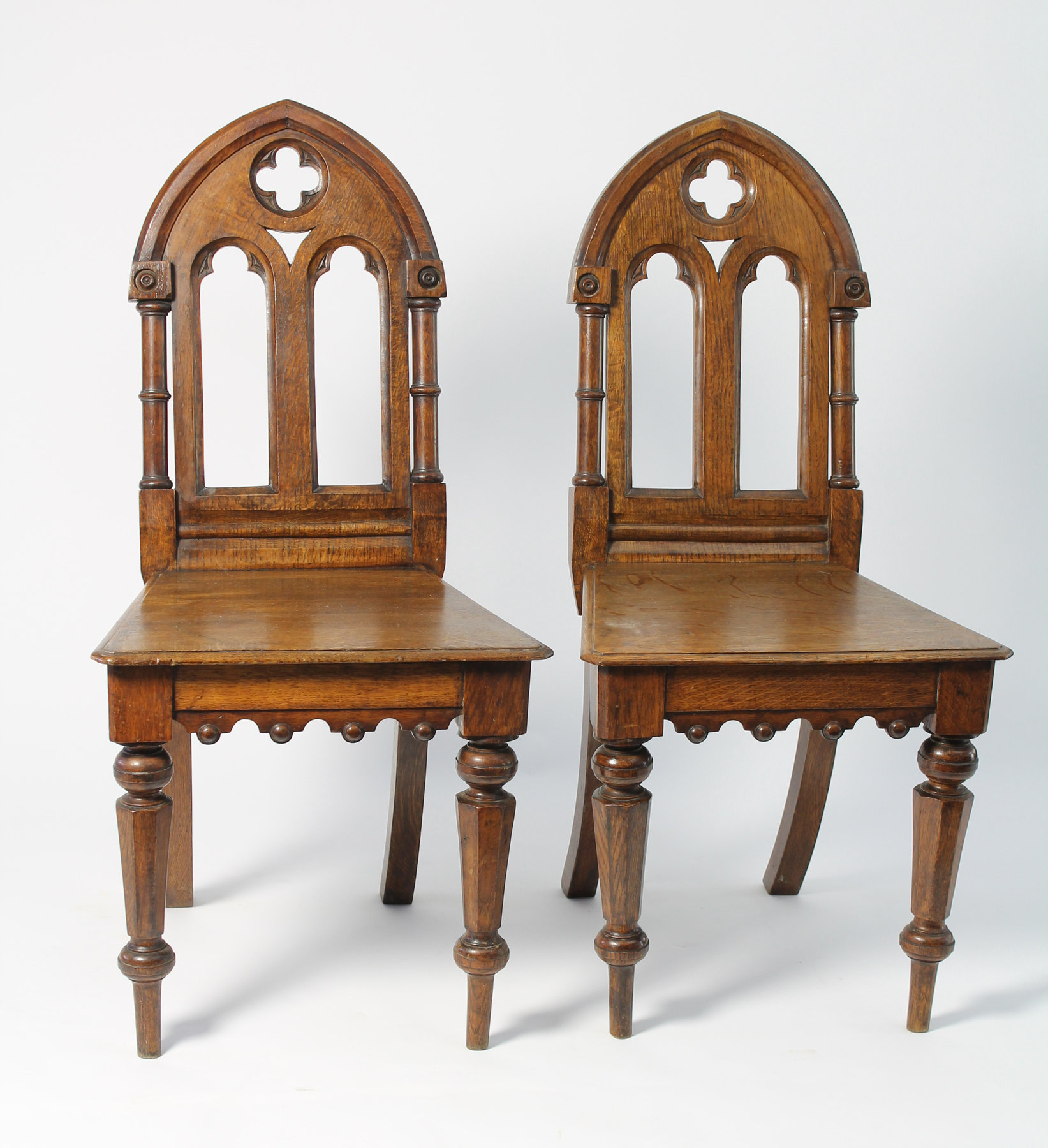 Appraisal: A pair of Victorian gothic revival hall chairs the arched