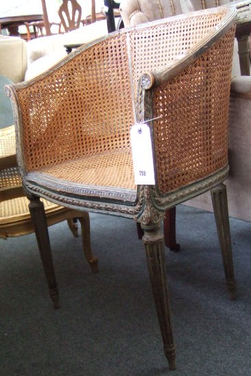 Appraisal: A th century French tub chair with ribbon carved frame