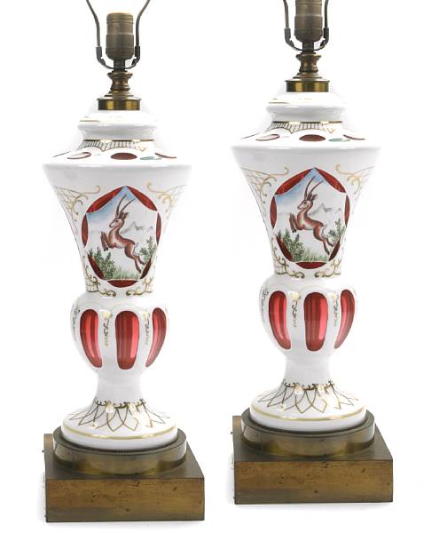 Appraisal: A pair of cased glass lamps centered with gazelles height