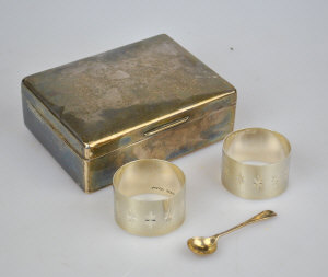 Appraisal: A silver cigarette box two napkin rings and a salt