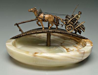 Appraisal: Cold-painted bronze horse log wagon crossing a bridge figure holding