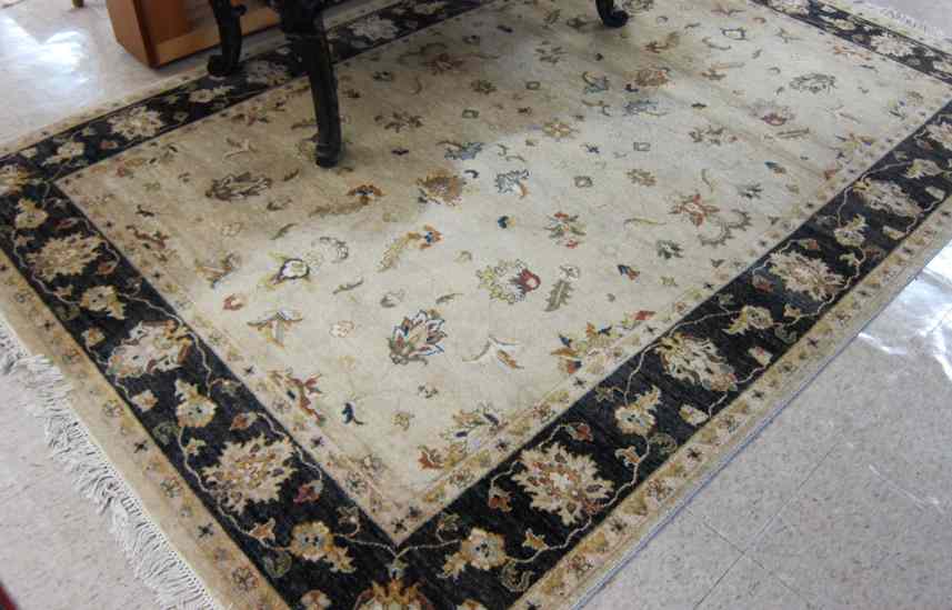 Appraisal: HAND KNOTTED ORIENTAL CARPET Pakistani-Persian having a foliate decorated tan