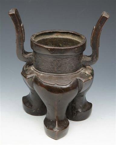 Appraisal: AN EARLY CHINESE BRONZE CENSER with shaped handles and incised