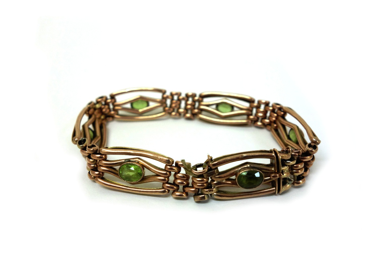 Appraisal: A gold and peridot set gate-link bracelet set with six