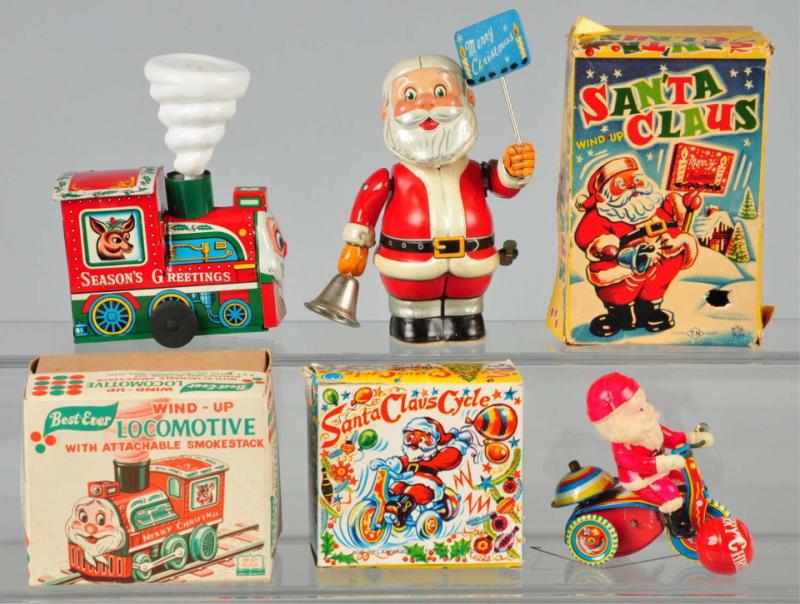 Appraisal: Lot of Santa Wind-Up Toys Description All are working Includes