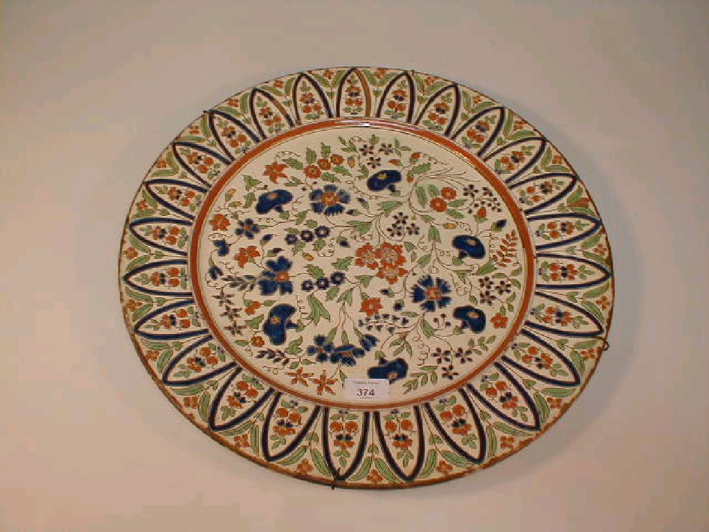 Appraisal: A continental pottery charger enamelled with flowers in blue green