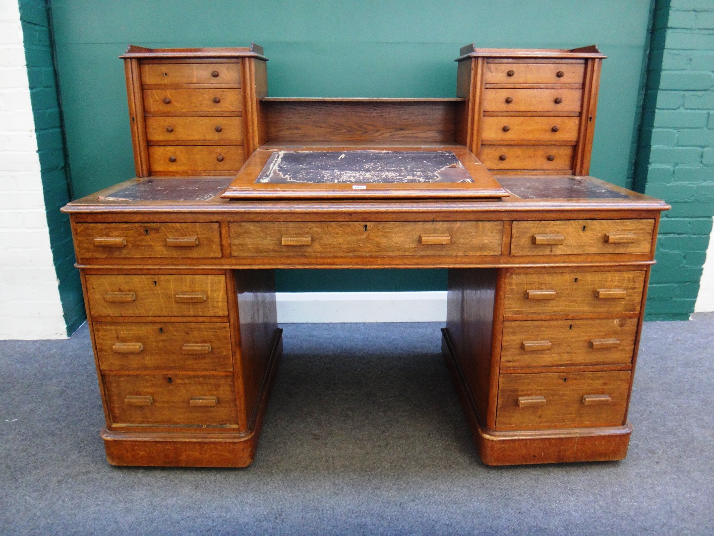 Appraisal: A th century oak 'Dickens' desk the slope front writing