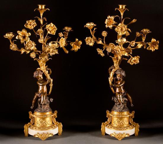 Appraisal: Pair of French gilt and patinated bronze putti-form four-light candelabra