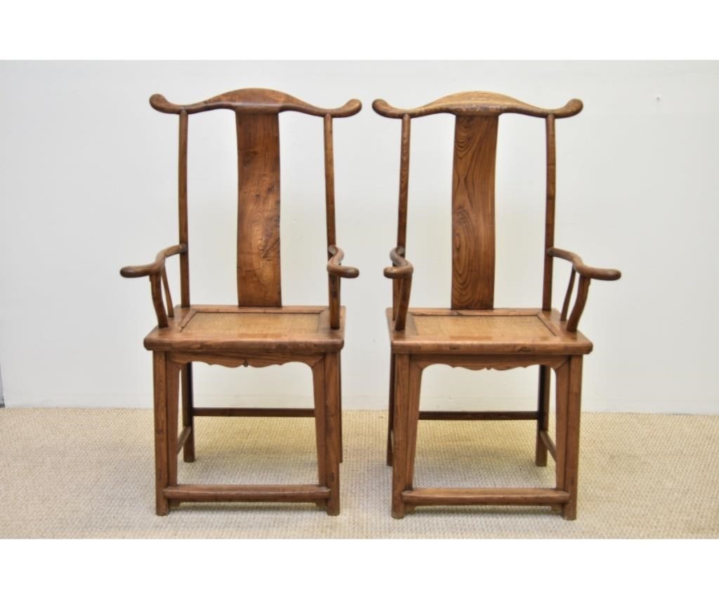 Appraisal: Pair of Chinese elm wood arm chairs with rattan seats