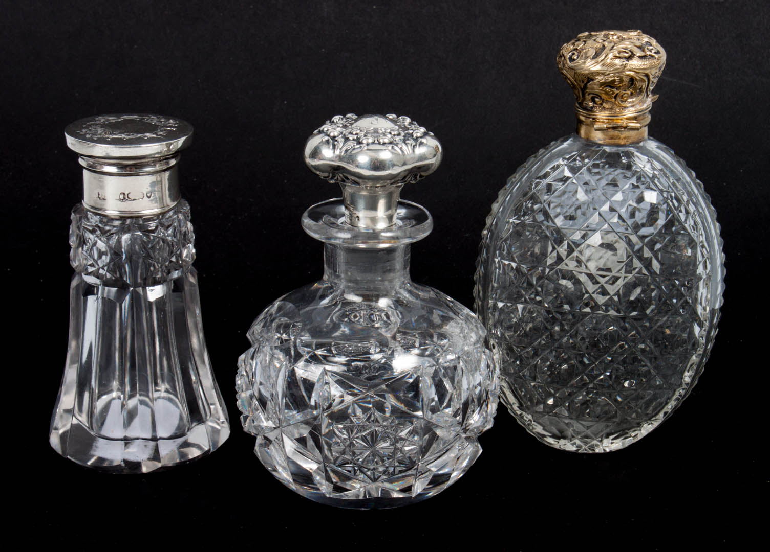 Appraisal: Three cut glass perfume bottles two with sterling silver lids