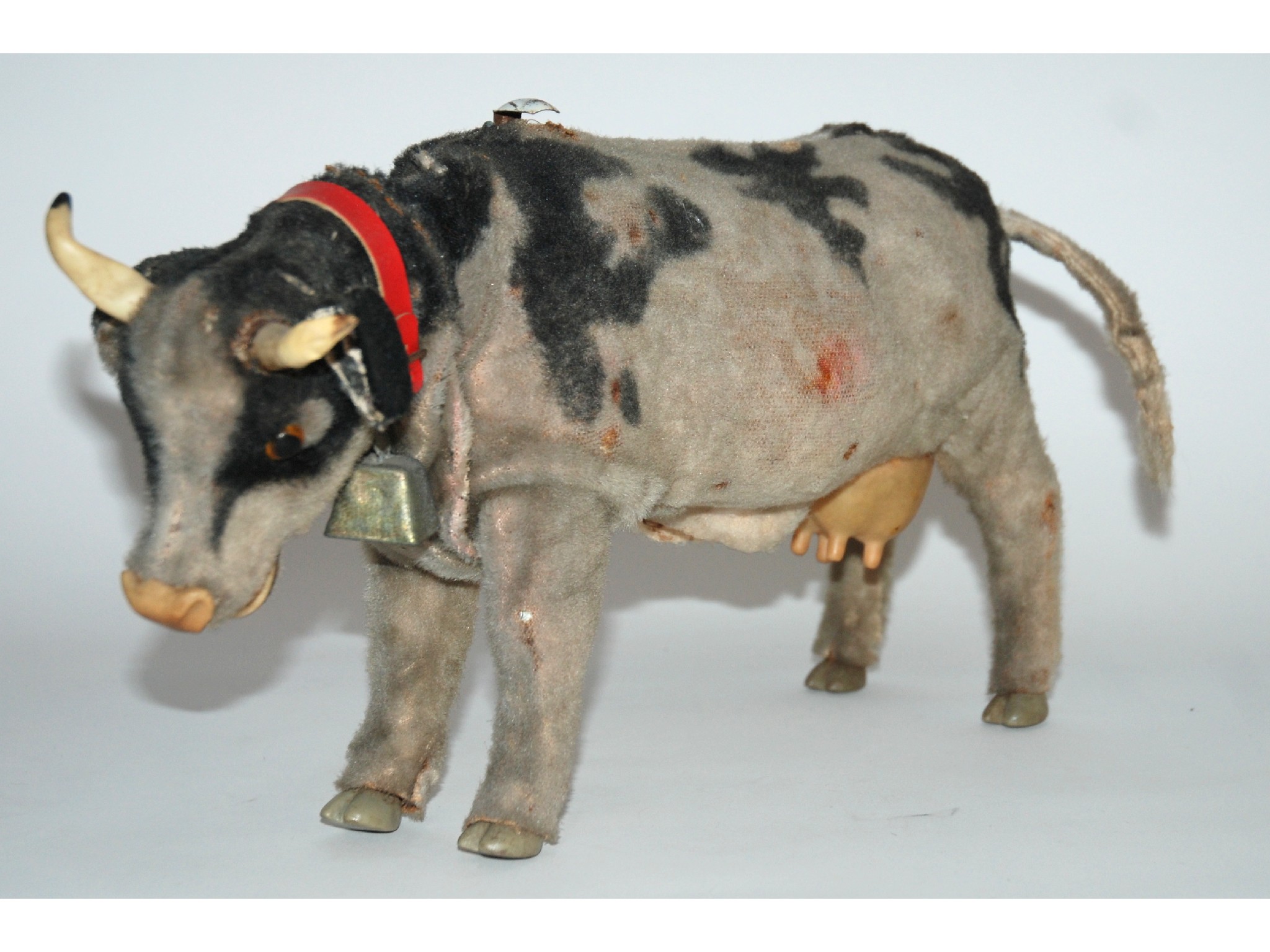 Appraisal: A battery-operated automaton mooing cowwith articulated head and legs felt