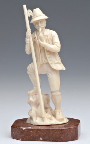 Appraisal: CONTINENTAL IVORY Carved figure of an Alpine mountain climber holding