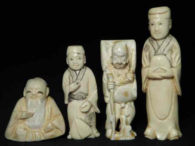 Appraisal: Four Japanese carved ivory Katabori netsukes Includes a large robed