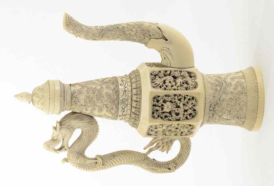 Appraisal: IVORY CARVED CHINESE COVERED EWER having dragon handle with stylized