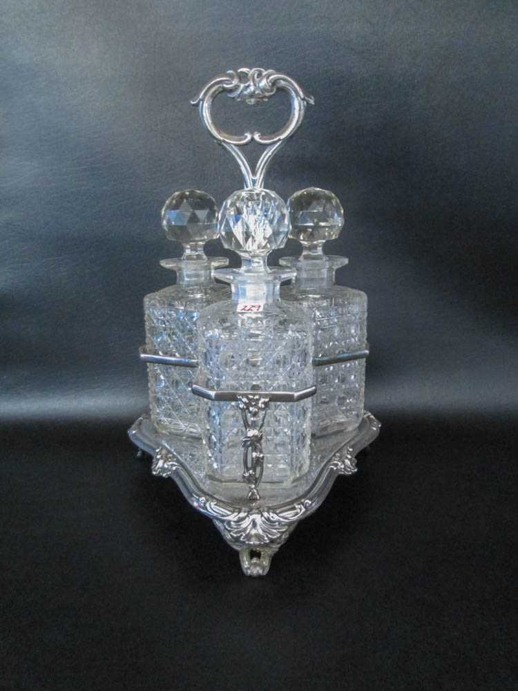 Appraisal: CUT CRYSTAL DECANTER SET AND SILVER PLATED CADDY three matching