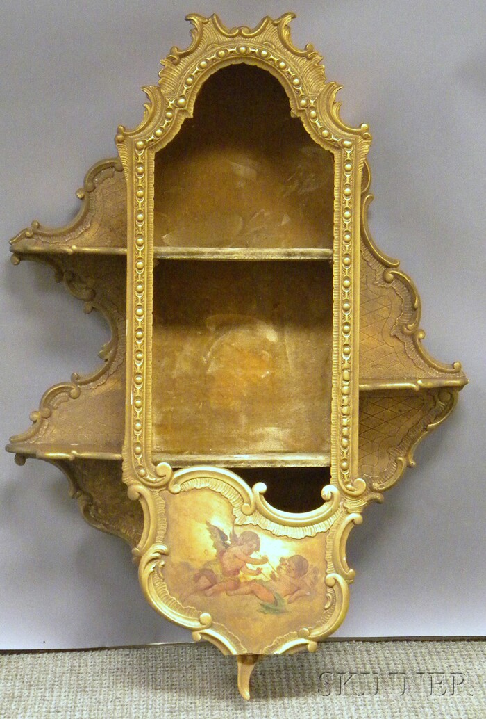 Appraisal: Rococo-style Carved Painted Cherub-decorated Giltwood Display Wall Cabinet lacking glass