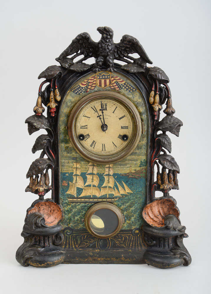 Appraisal: AMERICAN CAST IRON AND PAINTED SHELF CLOCK The paper dial