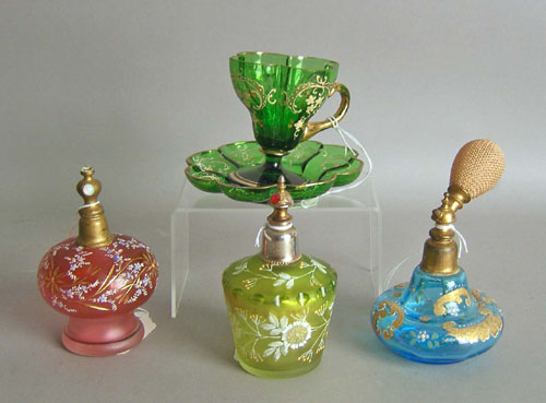 Appraisal: Three enamel decorated atomizers together with a cup and saucer