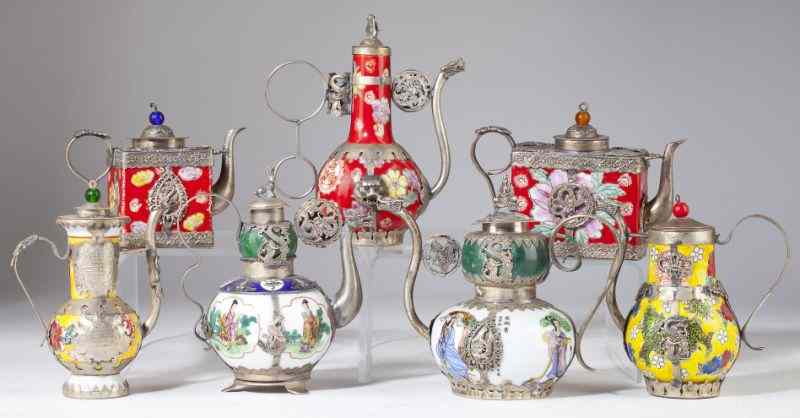 Appraisal: Group of Seven Chinese Silver Overlay Teapotsporcelain with silver bases