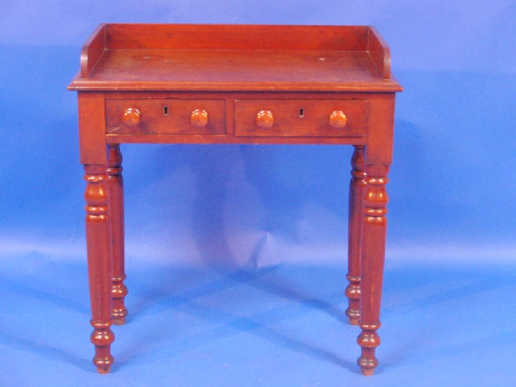 Appraisal: A small Victorian mahogany washstand with gallery and fitted with