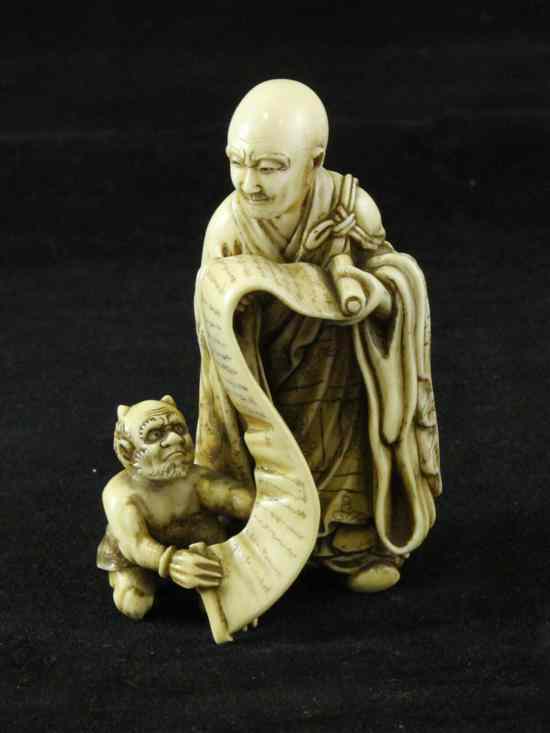 Appraisal: A Japanese ivory group of rakan and an oni early