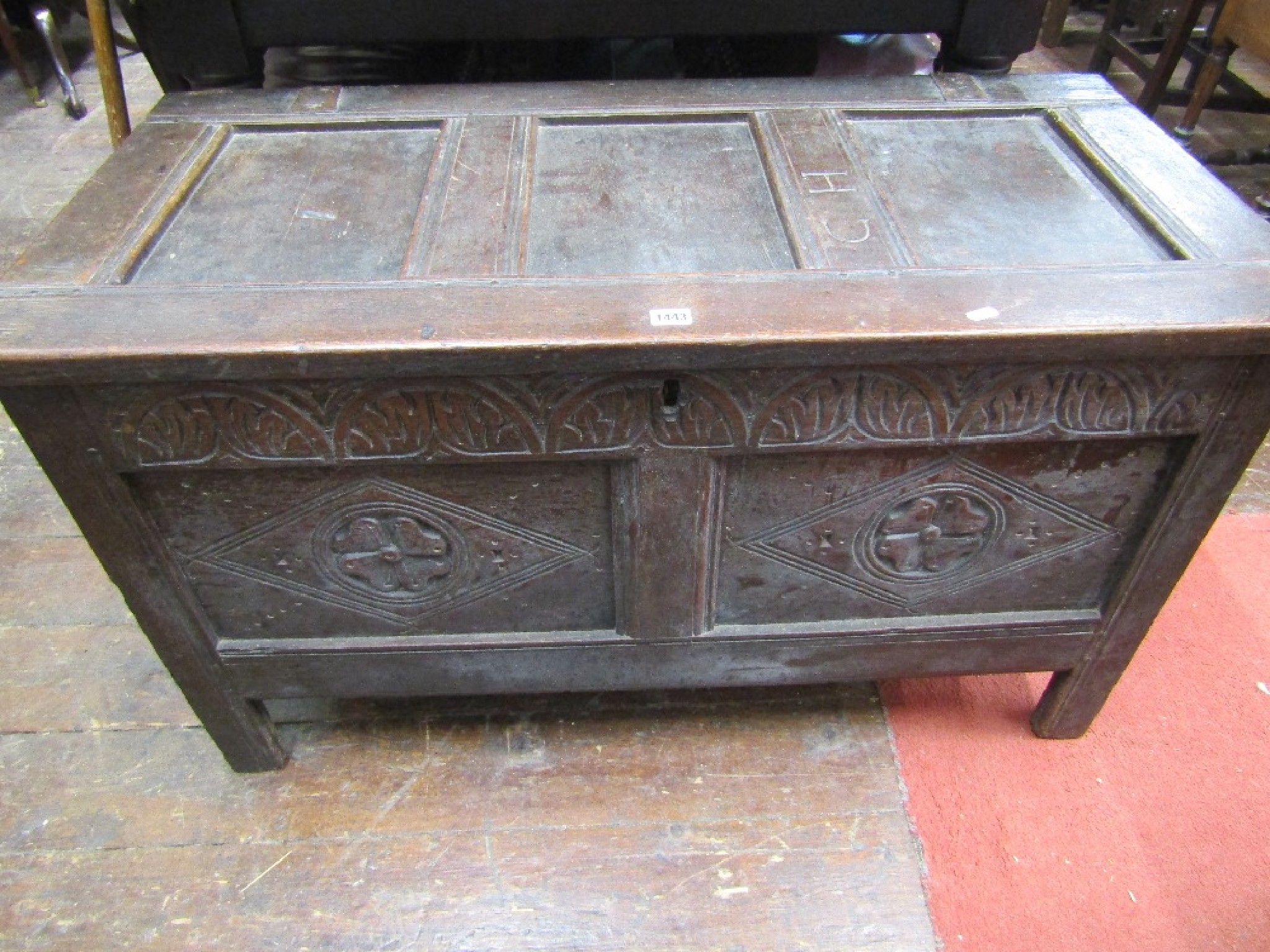 Appraisal: An th century oak coffer with panelled frame and carved