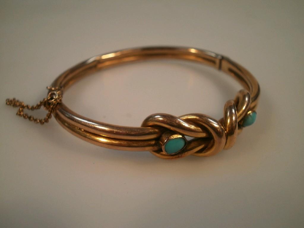 Appraisal: A Victorian hinged bangle with knotted front set with two