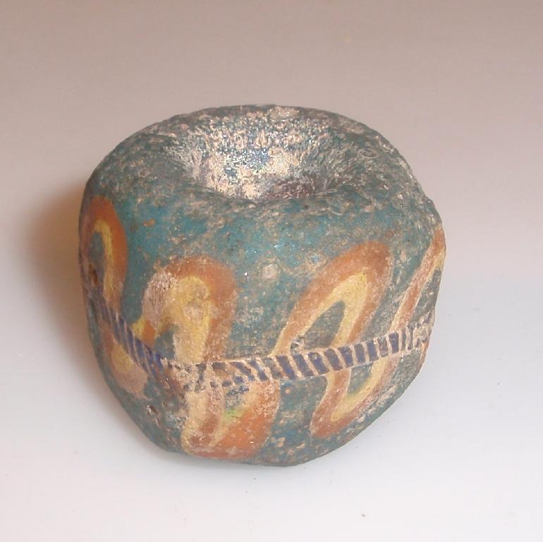 Appraisal: A large Islamic translucent turquoise square glass bead decorated with