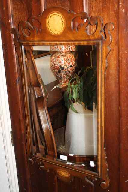 Appraisal: A CHIPPENDALE STYLE REPRODUCTION MIRROR with pierced frame shell inlay